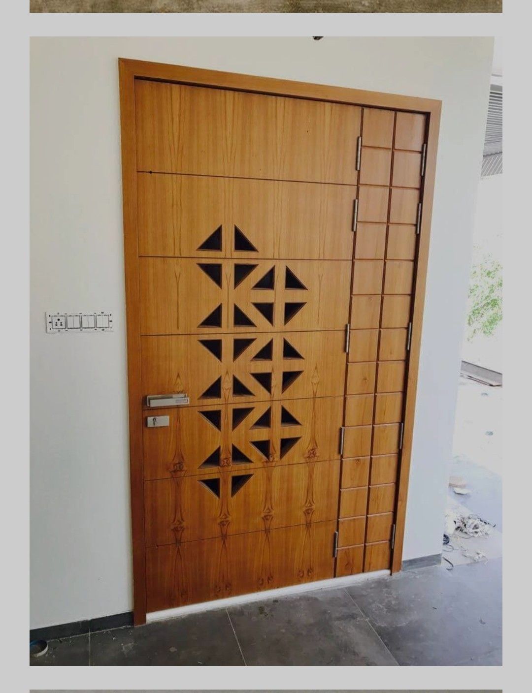 Modern Wooden Entry Door with Geometric Cutouts and Metal Grille