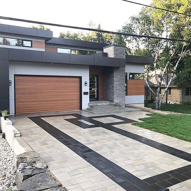 Modern Home Exterior With Geometric Paver Driveway and Wood Accents