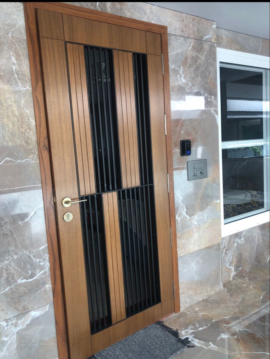 Modern Wood and Metal Entry Door with Marble Wall Surround