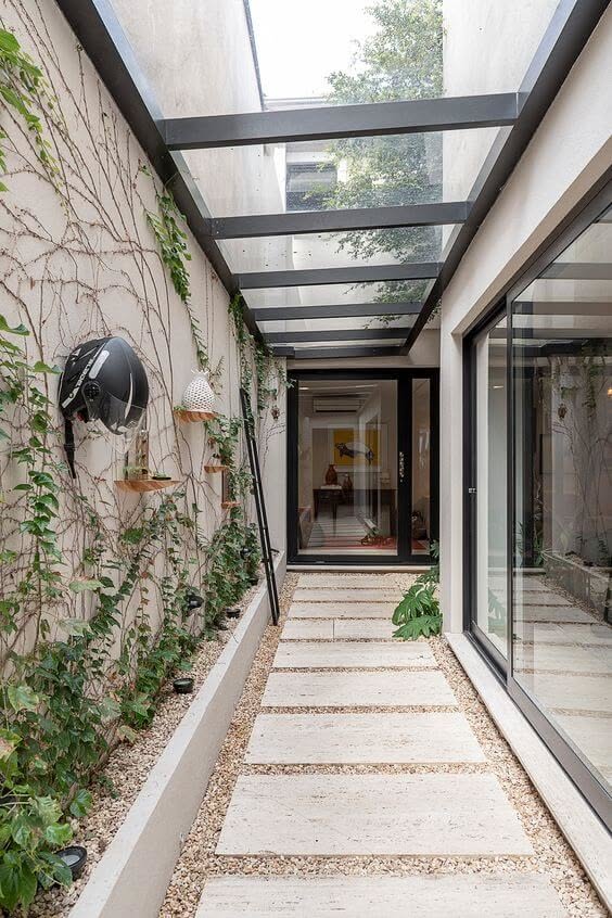 Modern glass-roof hallway with minimalist landscaping