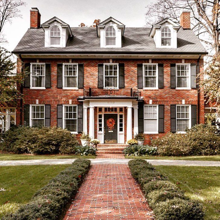 Classic Red Brick Colonial Home with Symmetrical Shutters and Dormers