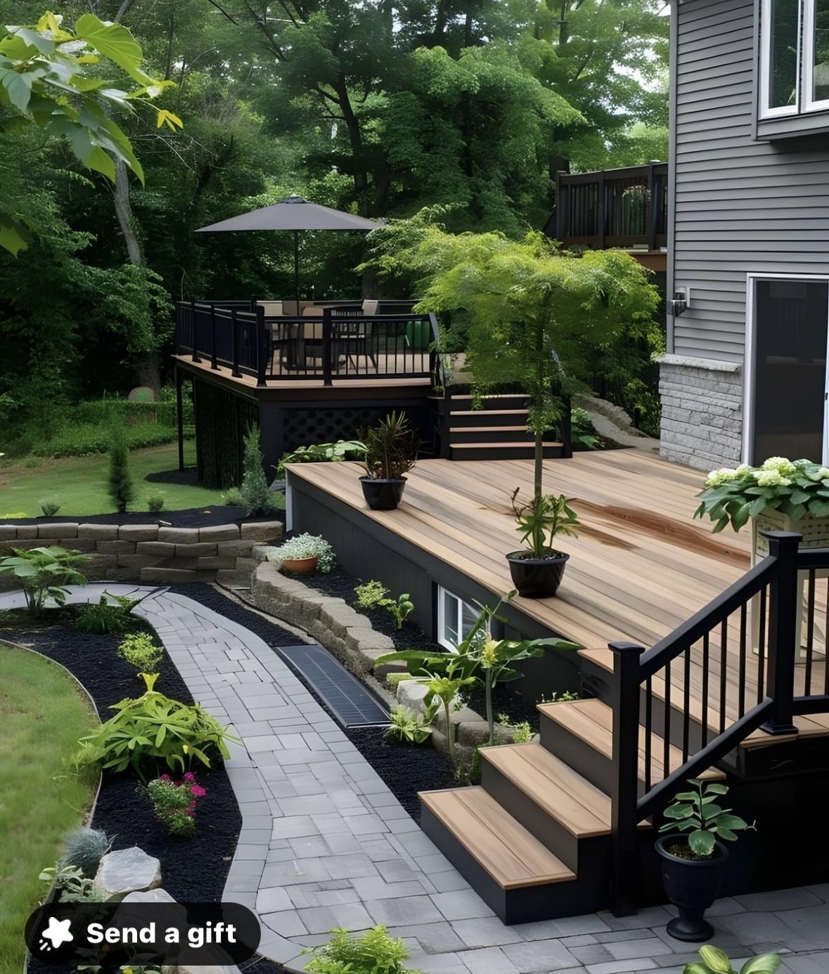 Multi-Level Backyard Deck With Modern Railings and Stone Walkway