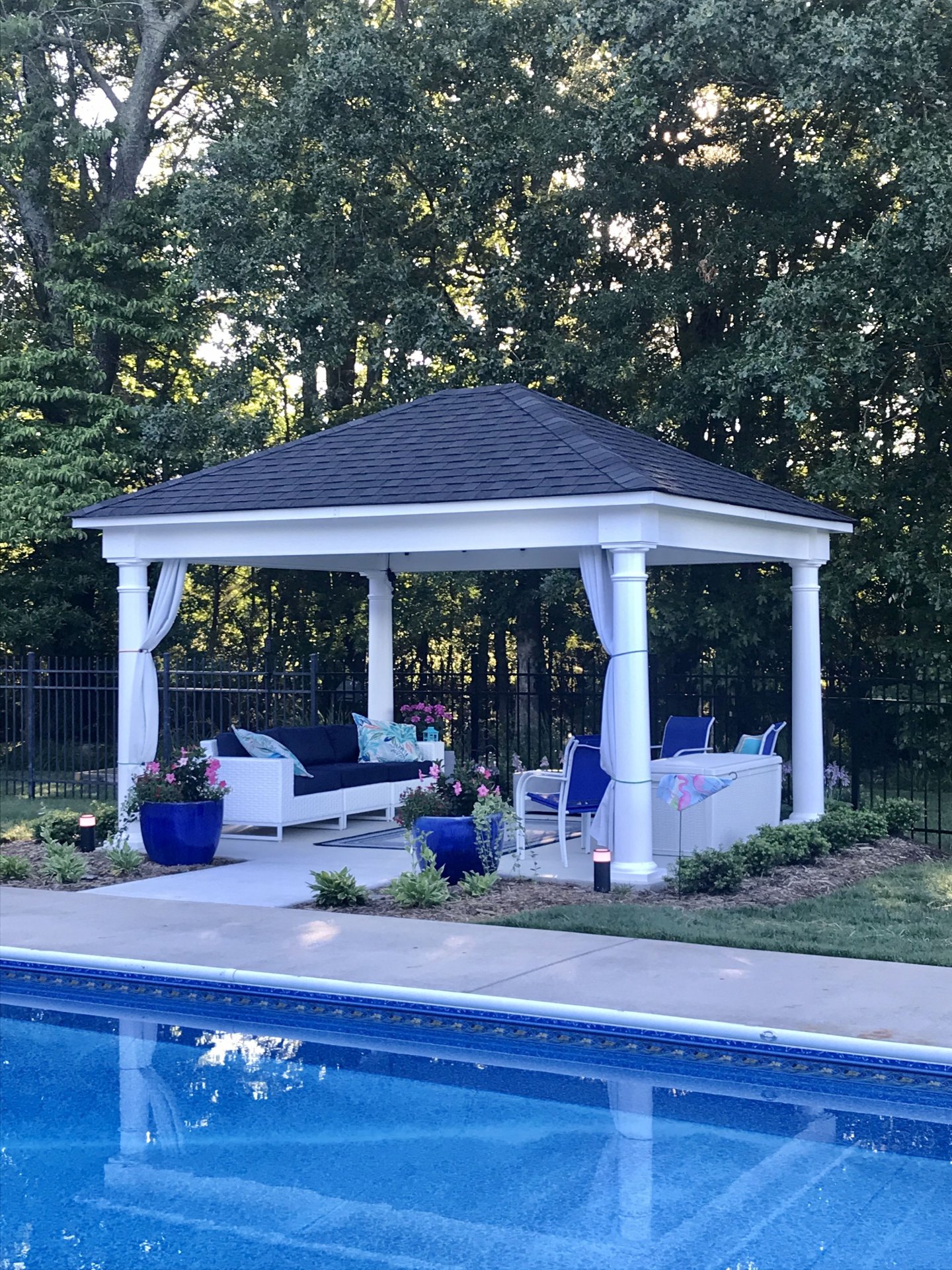 Poolside Gazebo with White Columns and Outdoor Lounge Seating