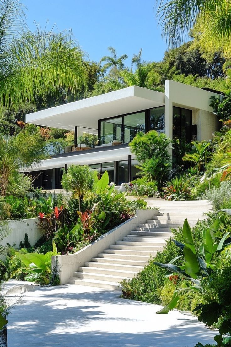 Modern Home with Expansive Glass Facade and Lush Tropical Landscaping