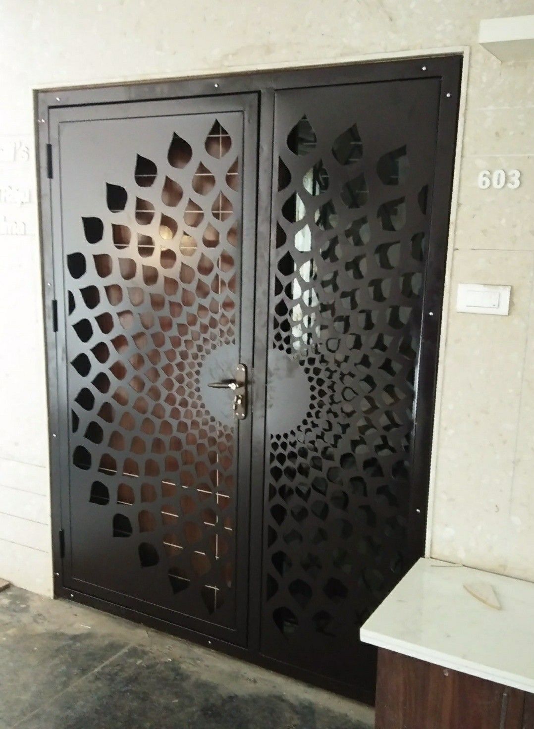 Modern Steel Security Door with Geometric Cutout Pattern for Entryway